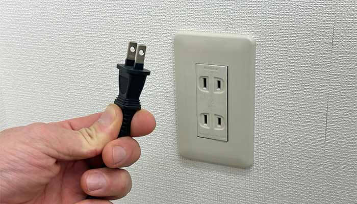 ONUと無線ルーターのACプラグをコンセントから抜く写真